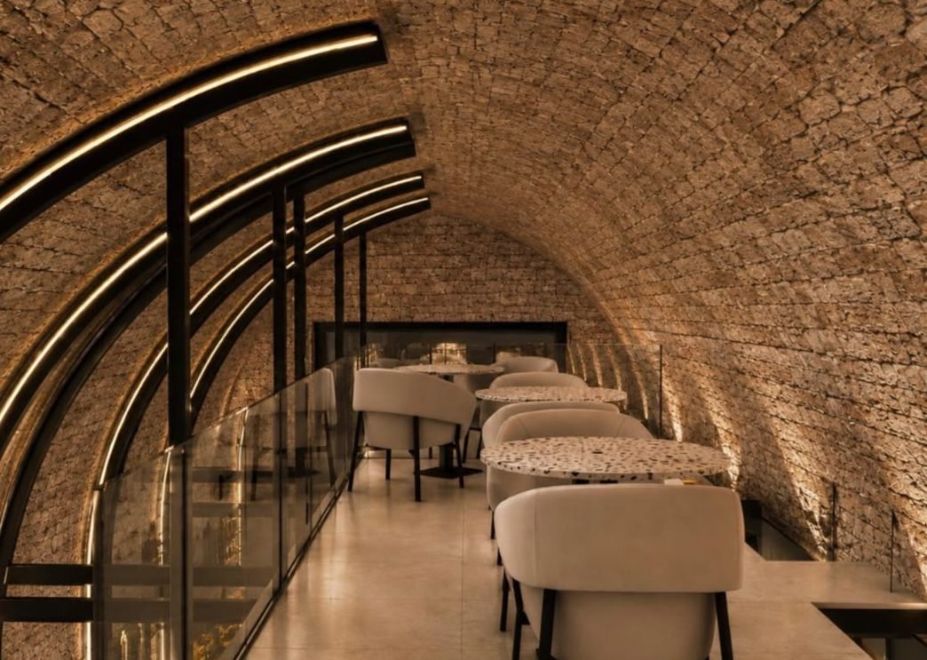 The mezzanine — a quiet row of tables under the vault